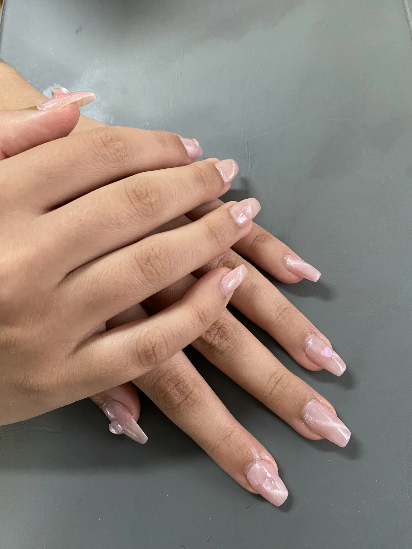 Long nude coffin nails — two crossed hands