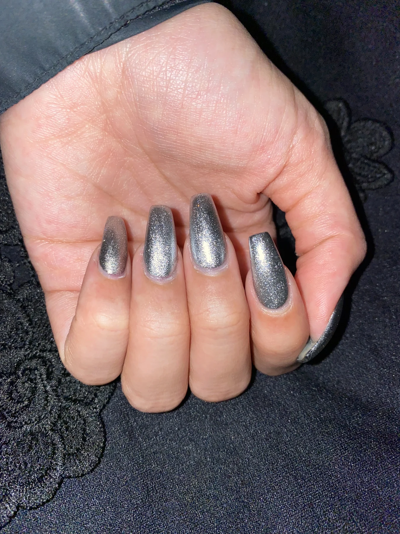 Silver-glitter coffin nails on dark denim