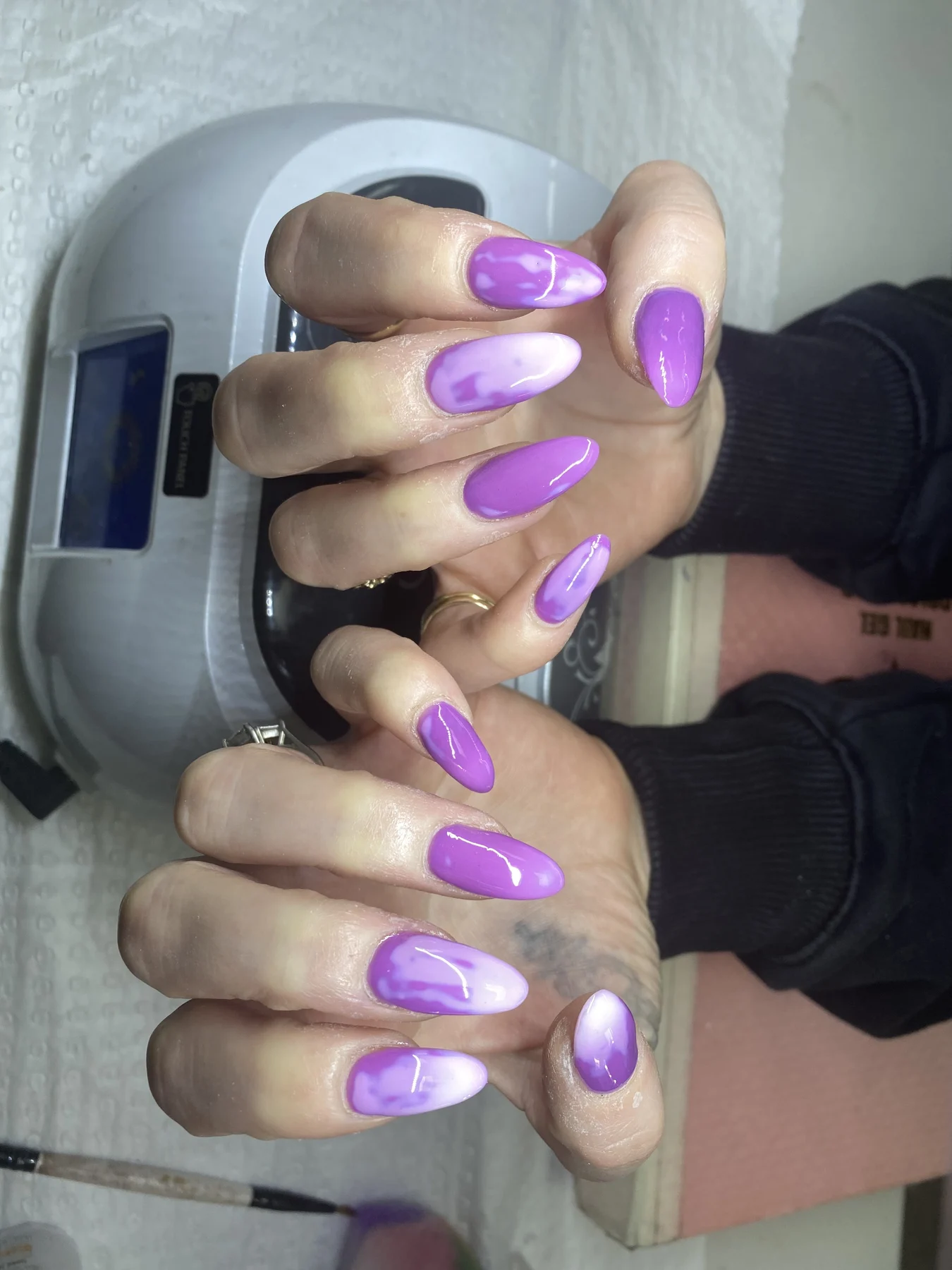 Purple ombre nails under UV curing lamp — work in progress